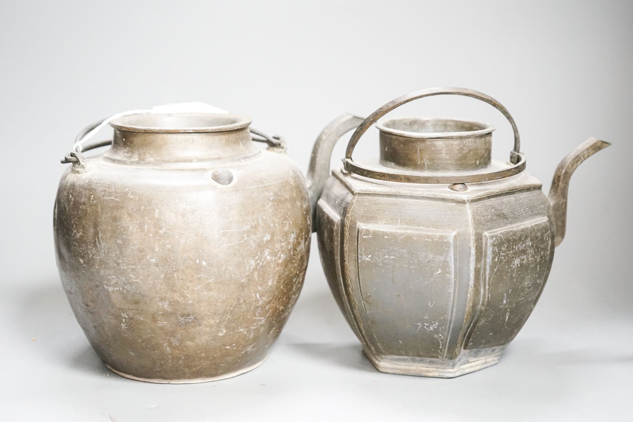 Two Chinese pewter teapots, late 19th/early 20th century, largest 23cm across